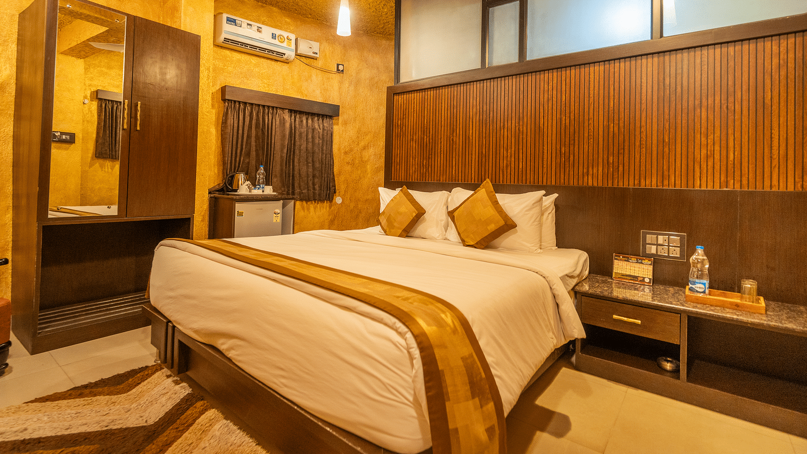 Image of a room with a bed and a wardrobe on the side at Coorg Jungle Camp Backwater Resort, Kushalnagar.