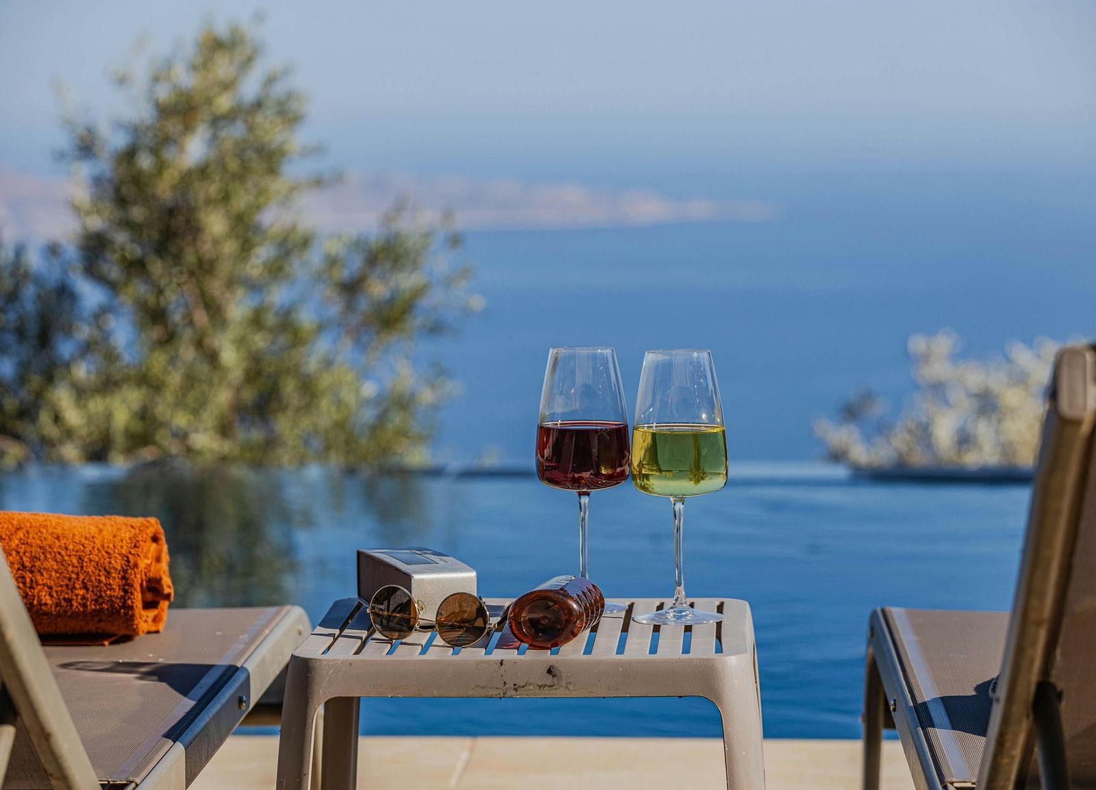 An image of two drinks placed on a coffee table and two lounge chairs overlooking the sea - Hotel 39, Jamaica