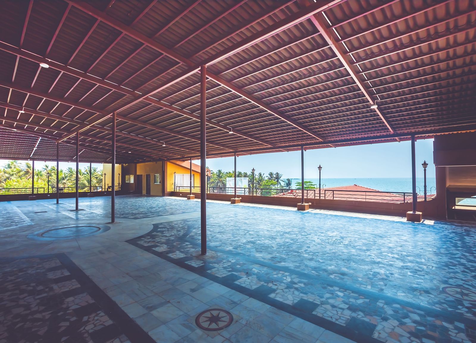 An outdoor event space covered using terracotta tiles at Paradise Isle Beach Resort, Udupi