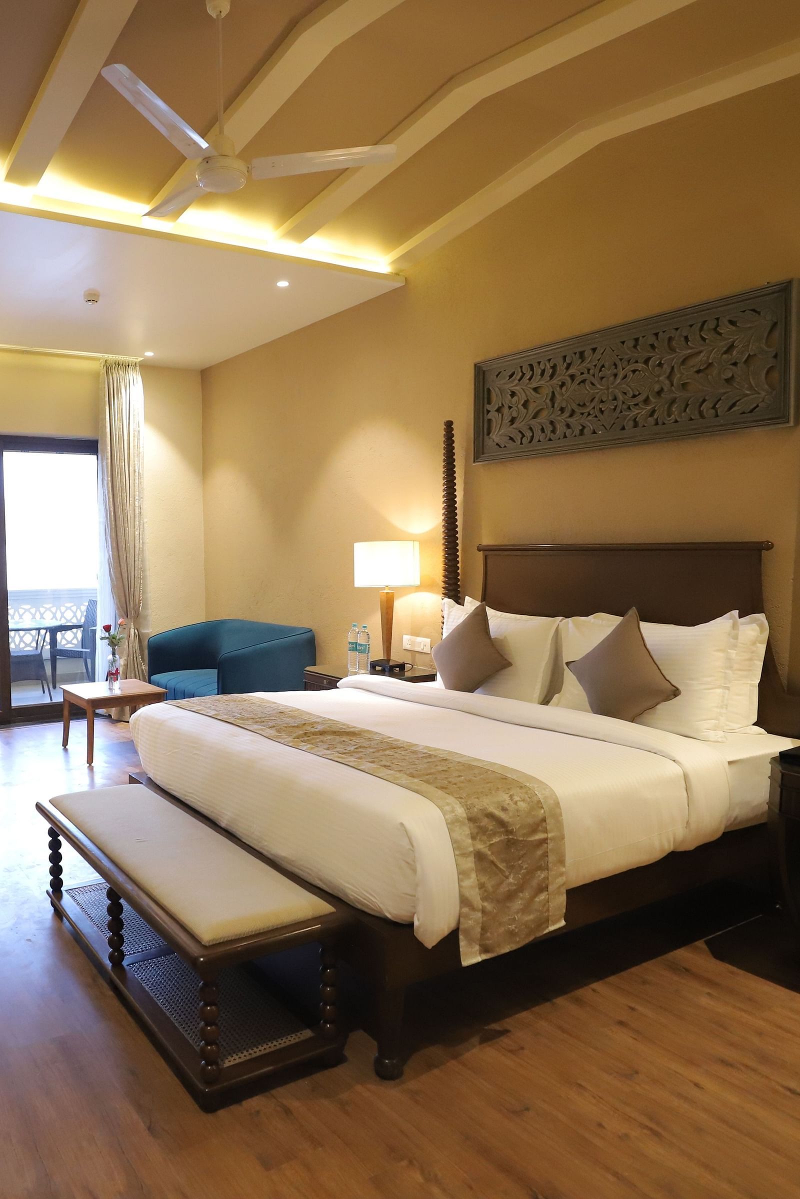 Premium room with a king size bed placed in front of a TV at Essentia Luxury Resort & Spa, Udaipur.