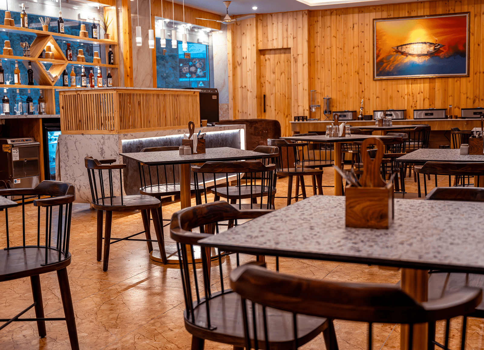 Image of the in-house restaurant featuring a fine dining setup, natural  lights and a coffee machine | The Tattva Devprayag