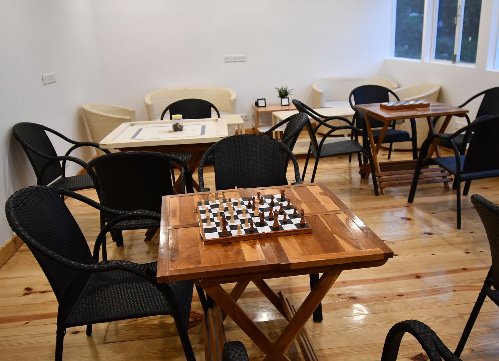 image of the indoor games area featuring a chess board kept on a wooden table at the tattva, joshimath