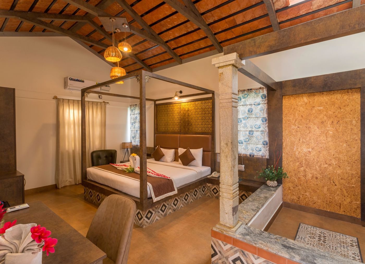 Elegant bedroom with wooden interiors and canopy bed at Nirantara Resort.