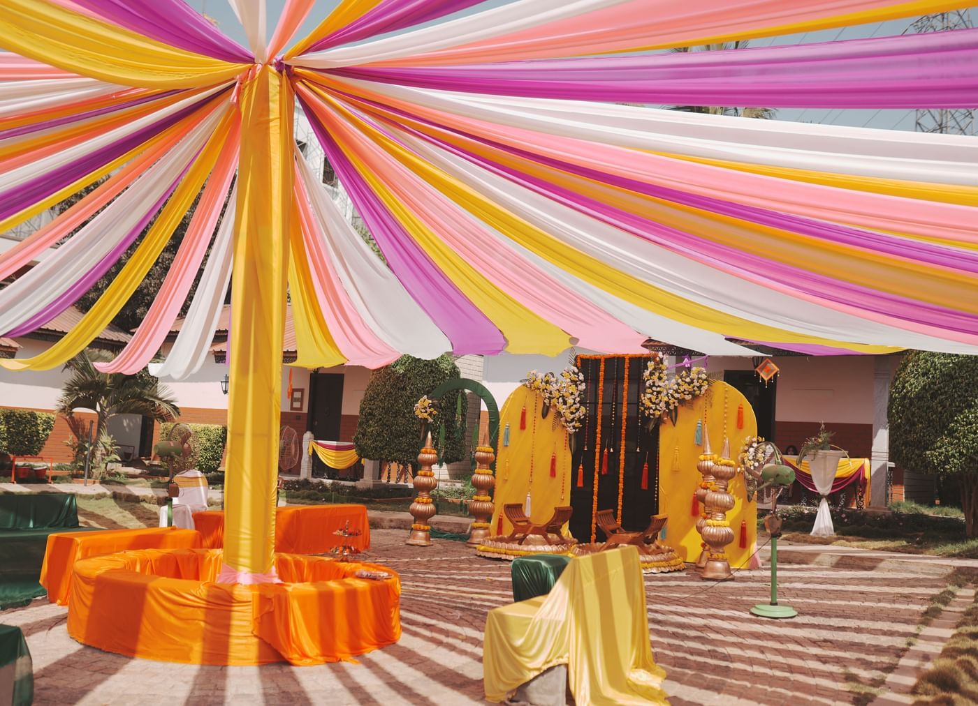 Colourful outdoor festive decor setup with canopy at Nirantara Resort.