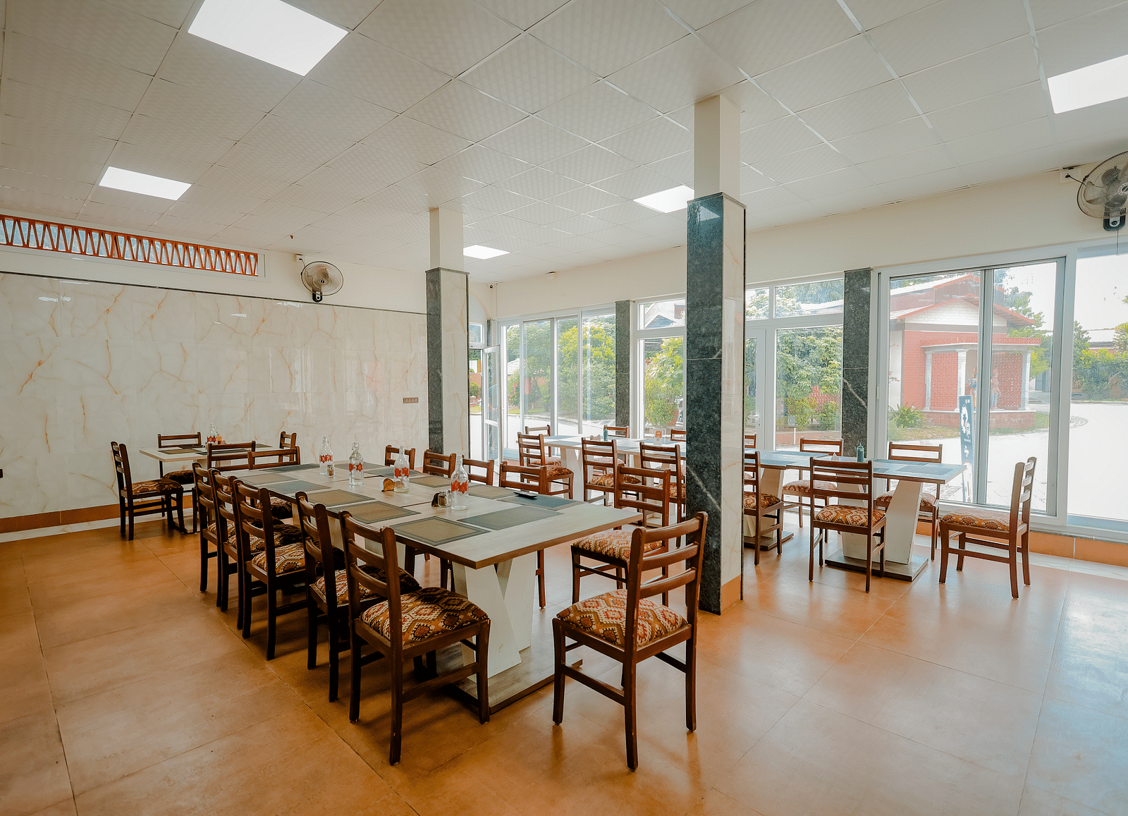 A dining area or event space with long tables and chairs at Nirantara Resort & Spa.