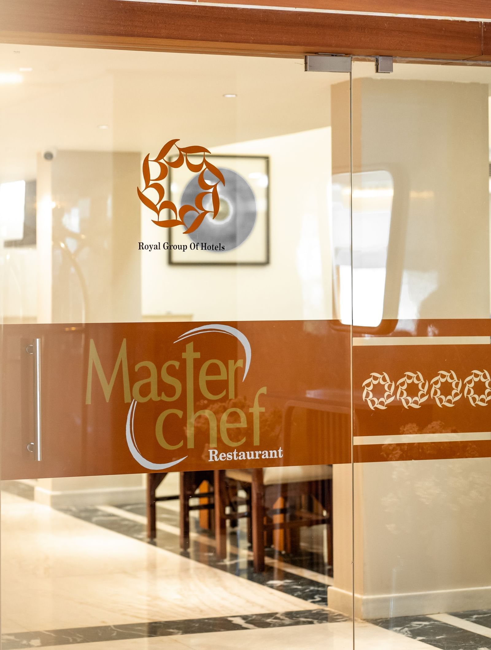 Entrance to Master Chef restaurant with glass door signage at Hotel Royal Regency Chennai