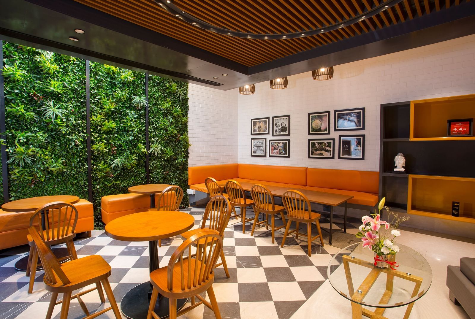 a room with large windows with views of trees and circular tables with chairs around them - Hotel Fountain Tree By TGI - JP Nagar, Bangalore