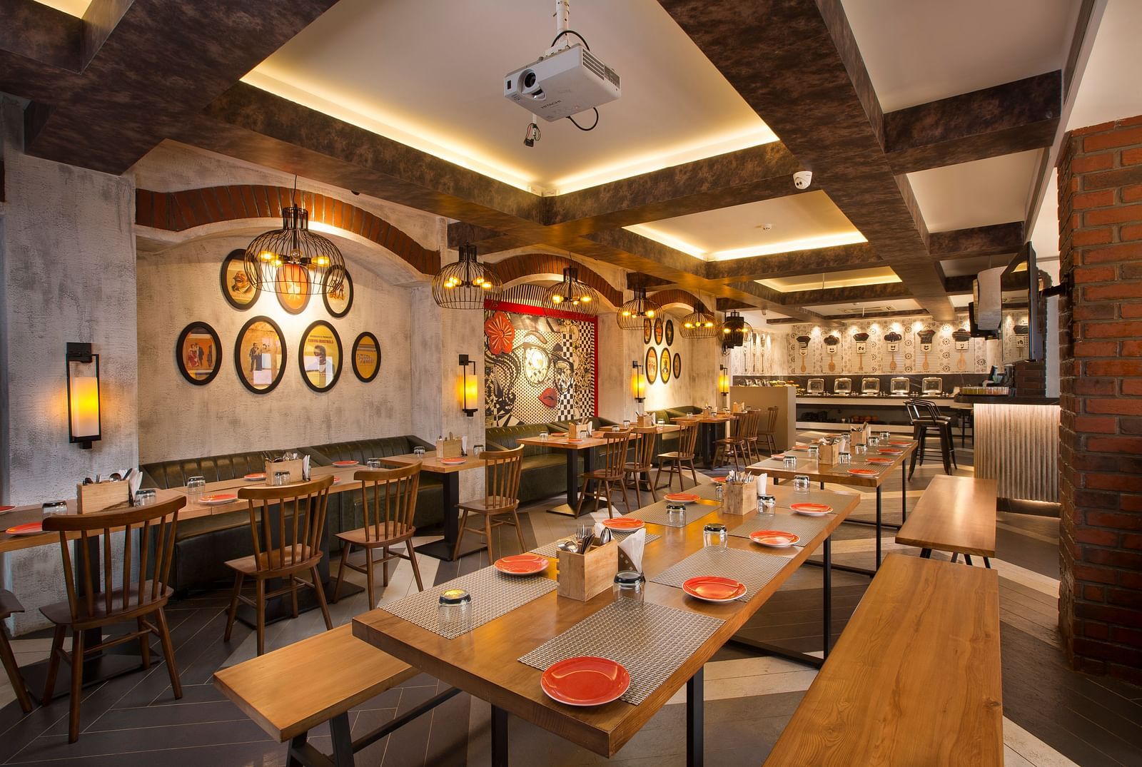 A cosy restaurant interior with wooden tables, pendant lighting and a buffet area in the background - Hotel Southend by TGI - Bommasandra, Bangalore