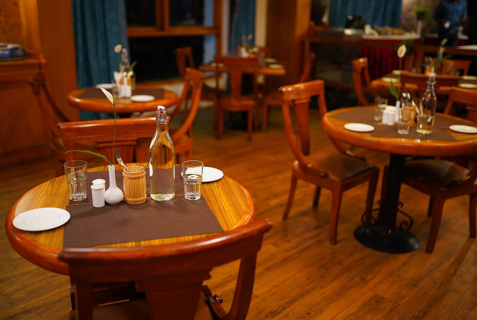 a view of dining table featuring clear plates and water bottles at La Montana By TGI, Ooty