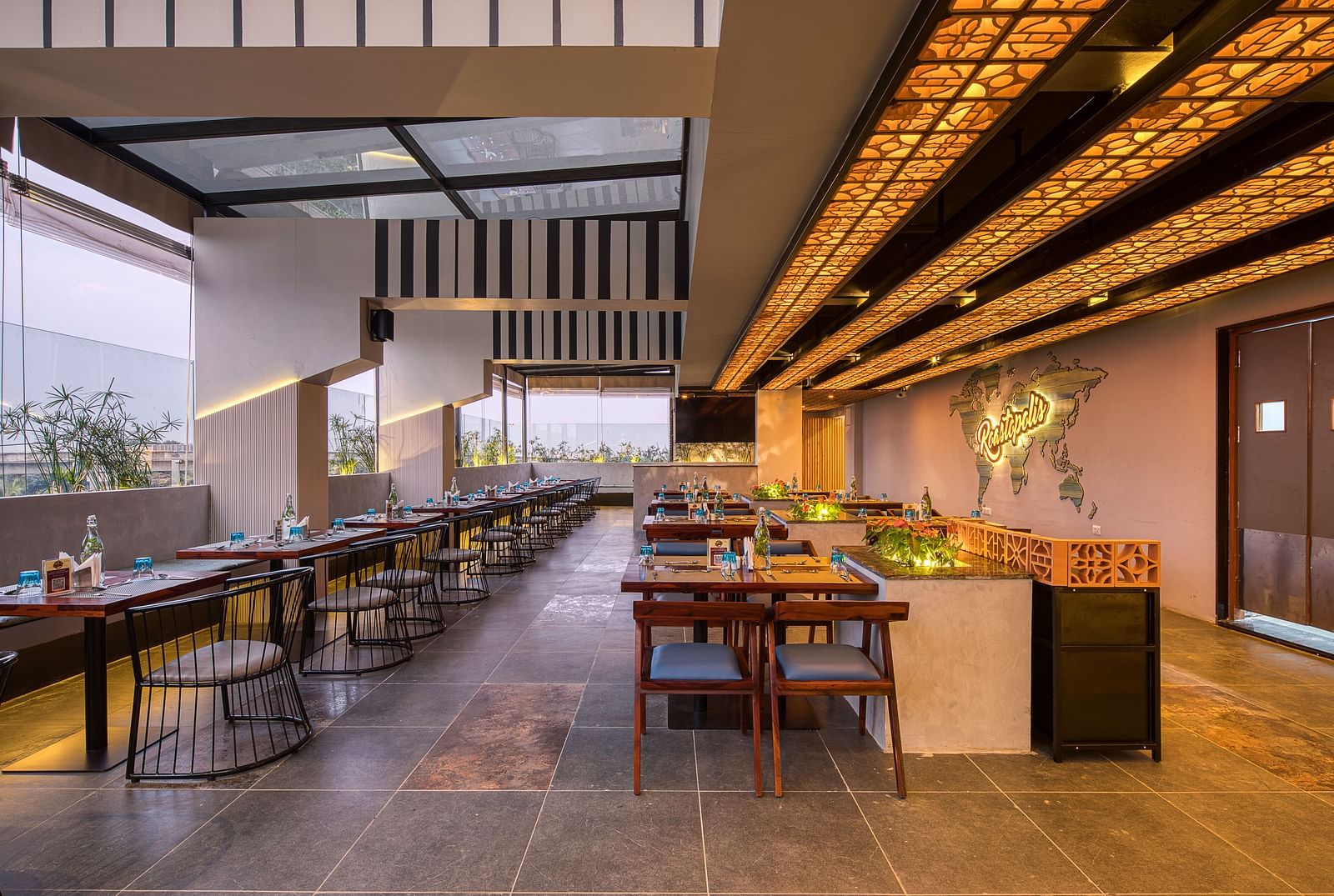 Interior of Roastopolis Restaurant at Le Foliage by TGI, Bangalore with tables and chairs
