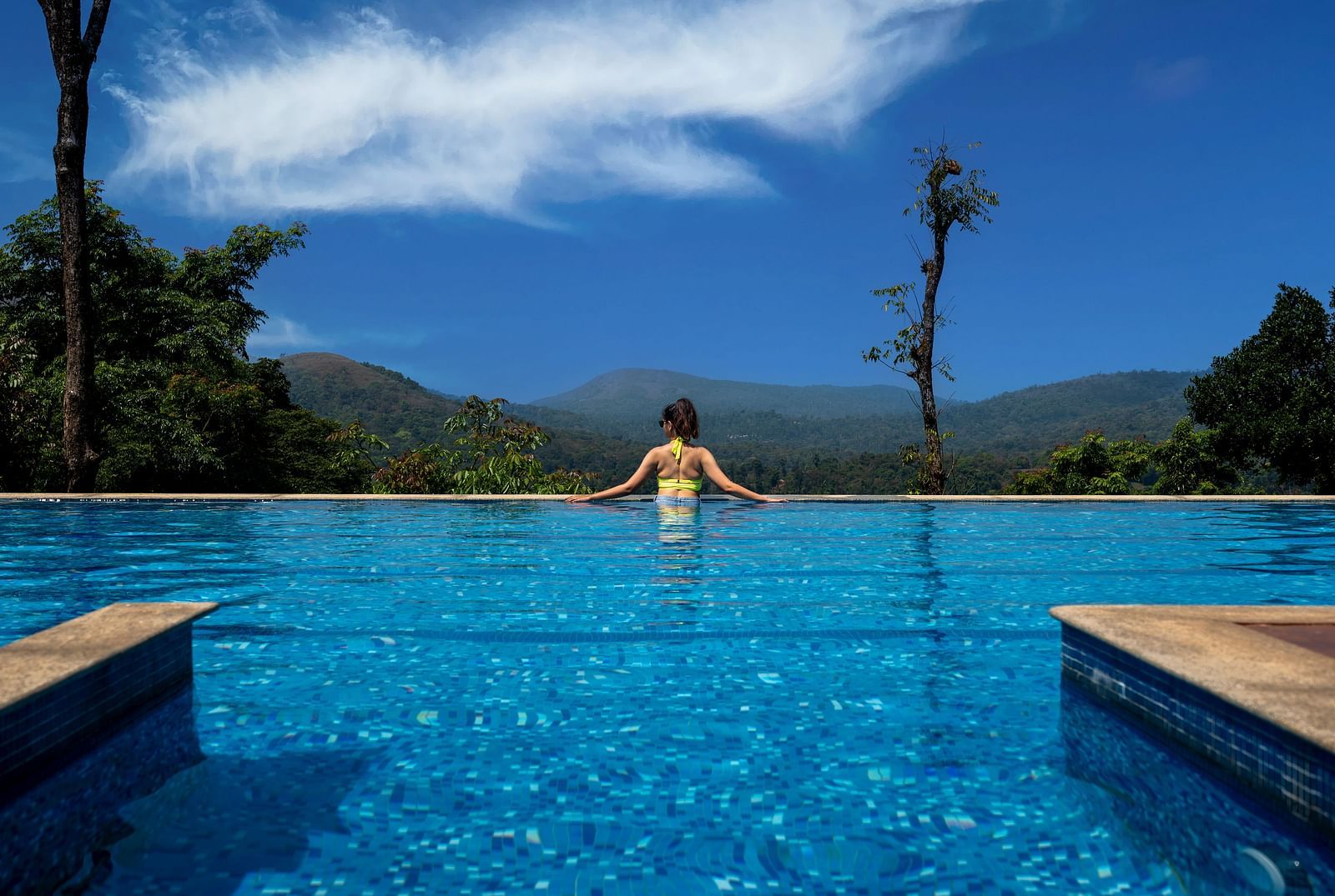  A person enjoying a serene view in a swimming pool