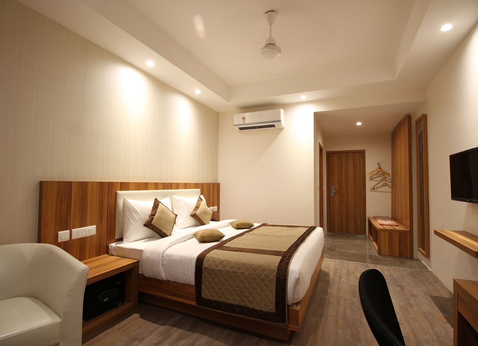 Corporate room with a posh bed and warm lighting captured from different angles while showcasing the in-3room amenities - the Le Roi Raipur Hotel
