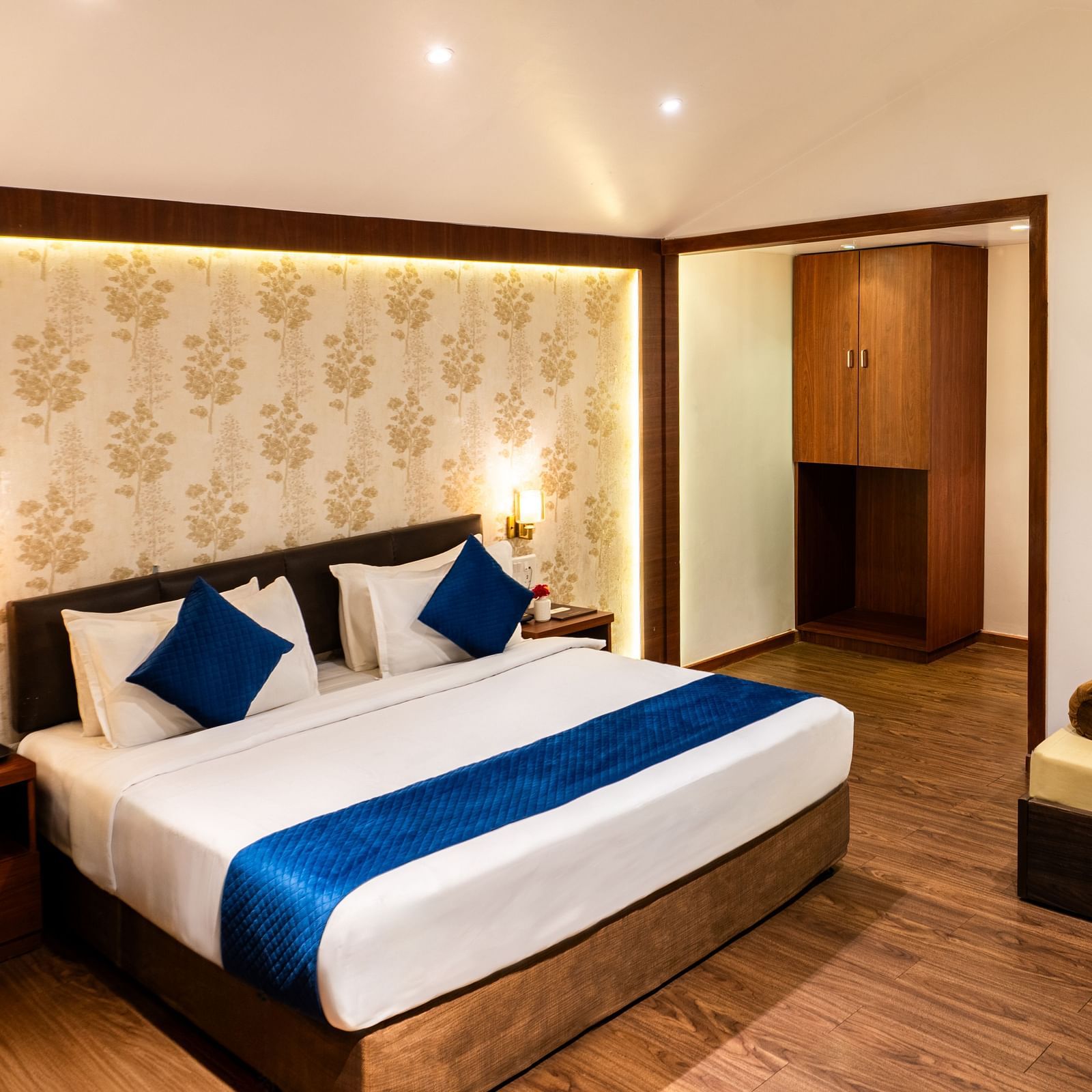 Lawn View Tent Room at The Grand Legacy Resort and Spa featuring room with double bed, blue accents, warm lighting, wood flooring, a lounge area, and Mars-themed wall art.