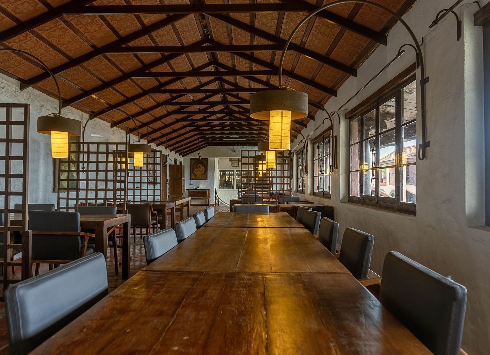 Spacious dining hall with wooden tables and beams  | Mango Hill, Yercaud