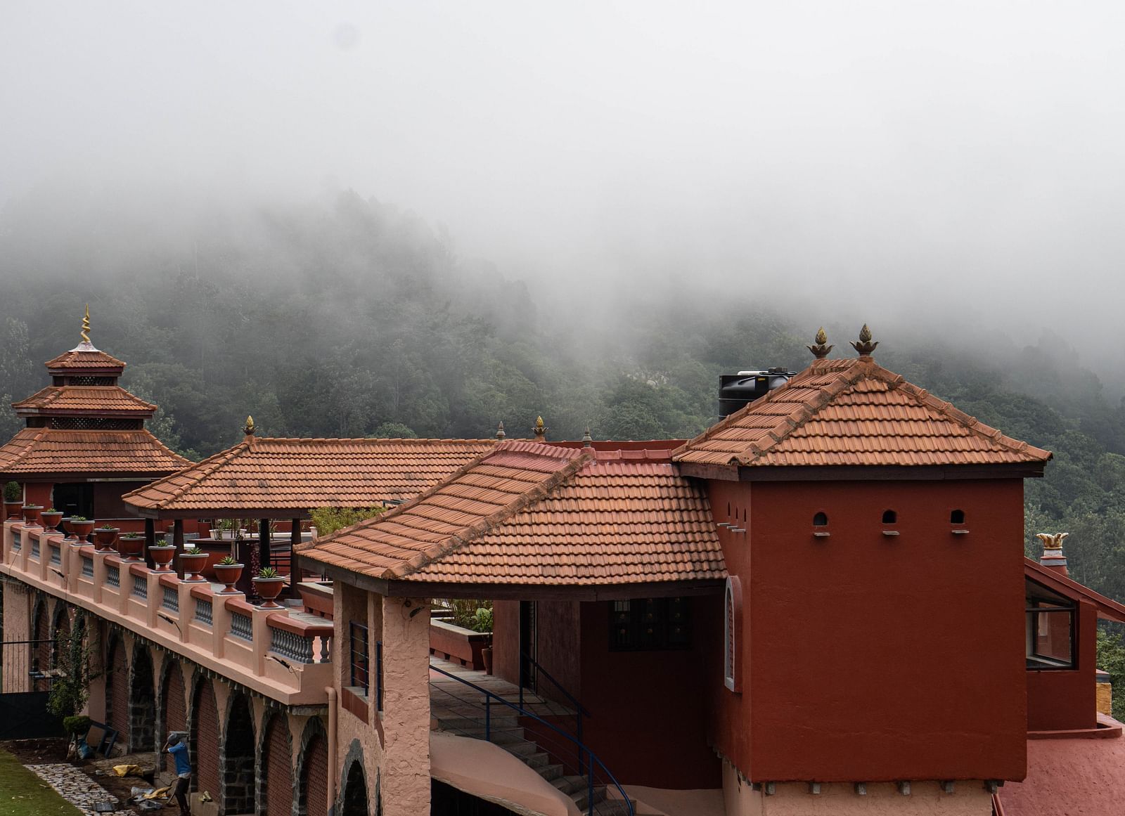 A beautiful facade of the resort with mist around  | Mango Hill, Yercaud