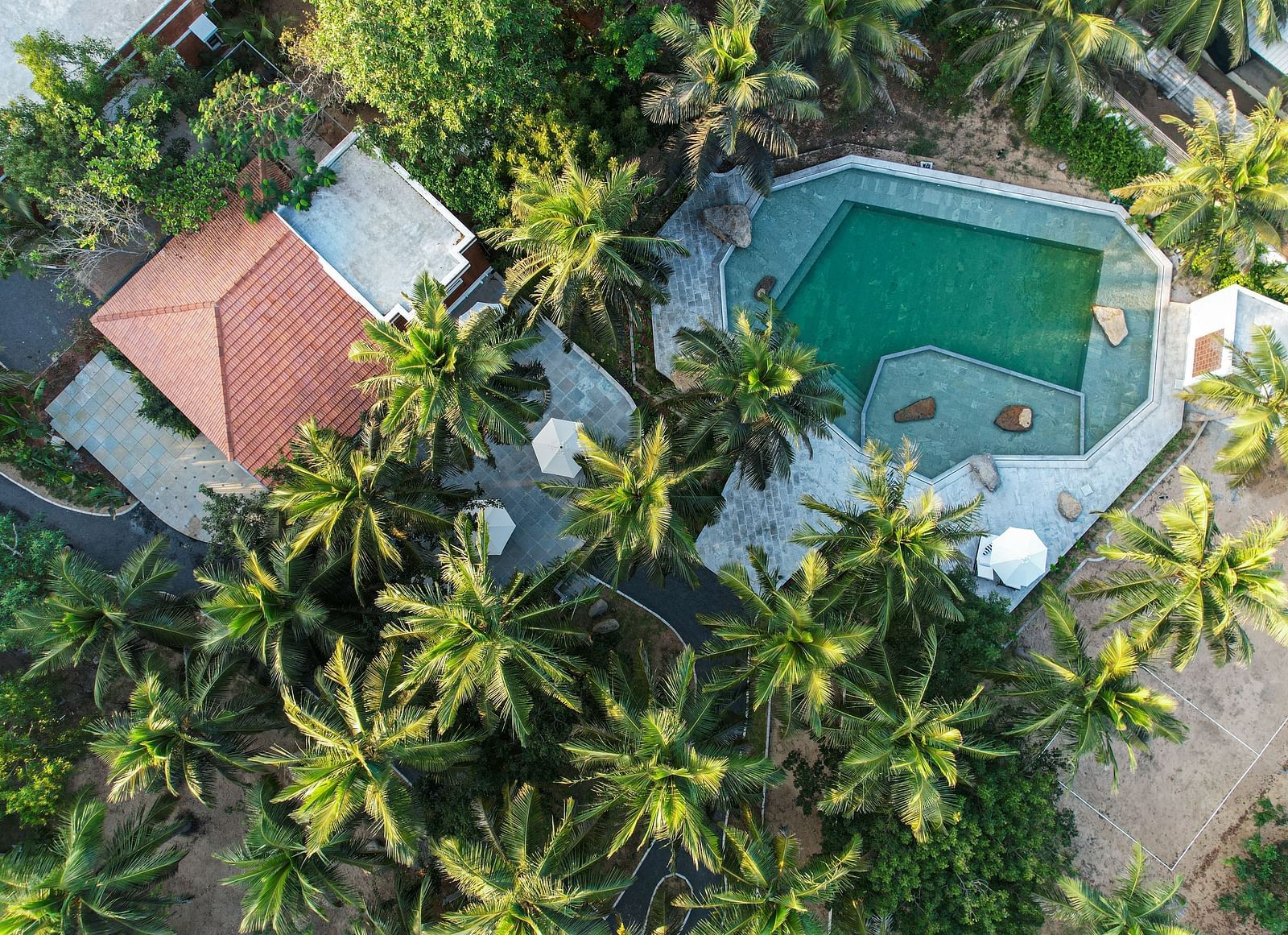 Aerial view of a private beach resort near Pondicherry with a swimming pool | Mango Hill Shallow Beach Resort ECR