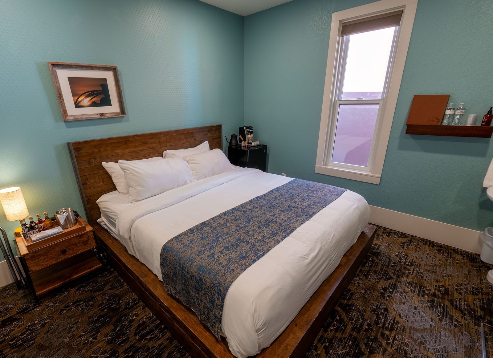 Elegant guest room with a plush bed and soft lighting for a restful stay at The Groveland Hotel.