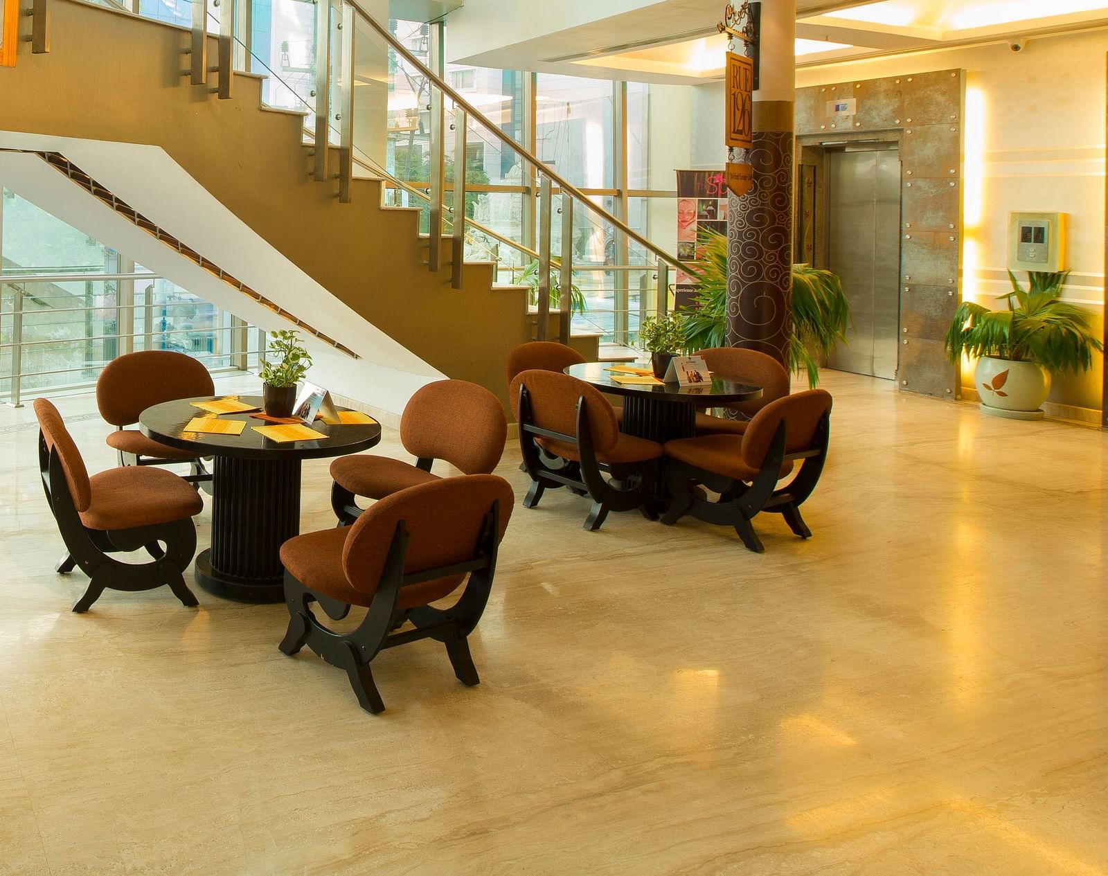 lobby of Hotel Atithi - TGI Grand, Pondicherry arrayed tables and chairs