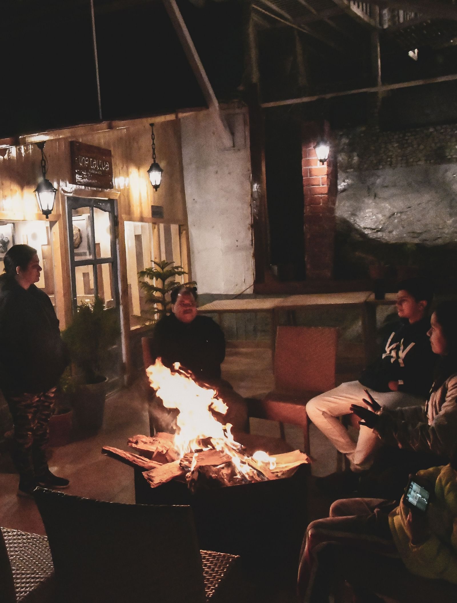 image featuring a family basking in the warmth of the bonfire at the tattva, joshimath