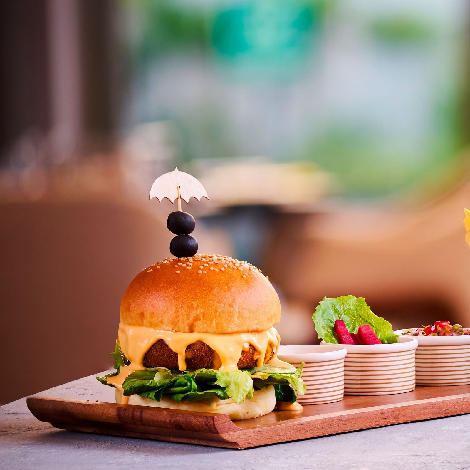A meal of french fries and burger placed next to a blue drink.