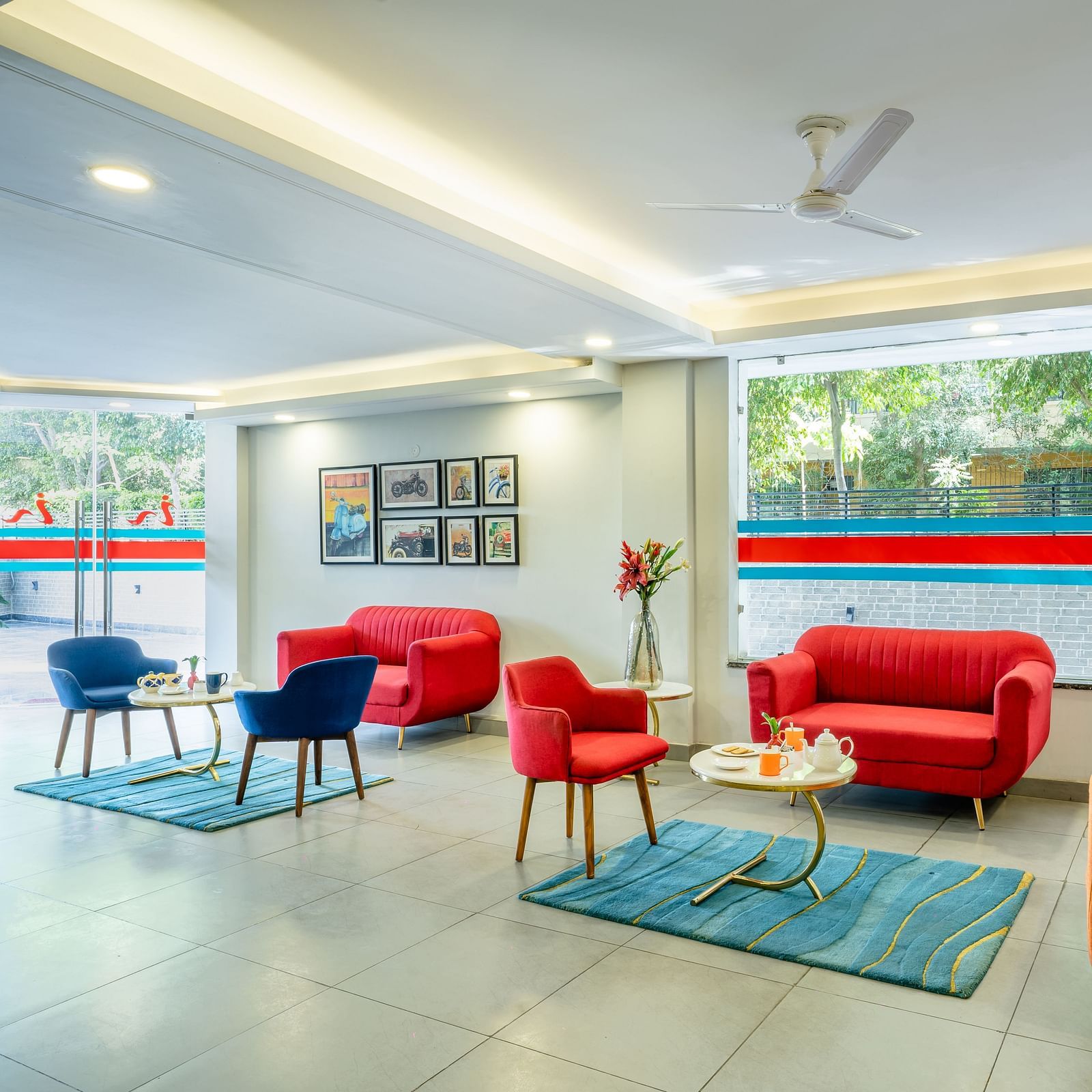 An image of a lobby with two sitting arrangements | Inde Hotel Golf Course Extension