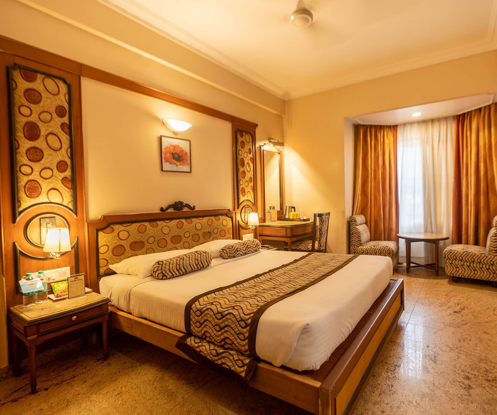 The Executive Room at Hotel Pai Viceroy Jayanagar featuring warm interiors and a queen sized bed amongst other amenities