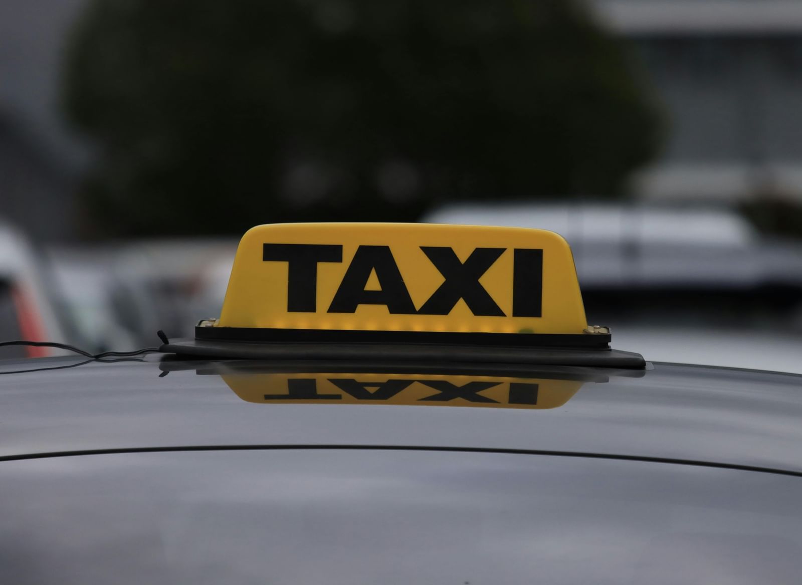 A 'Taxi' sign displayed on the roof of the car.
