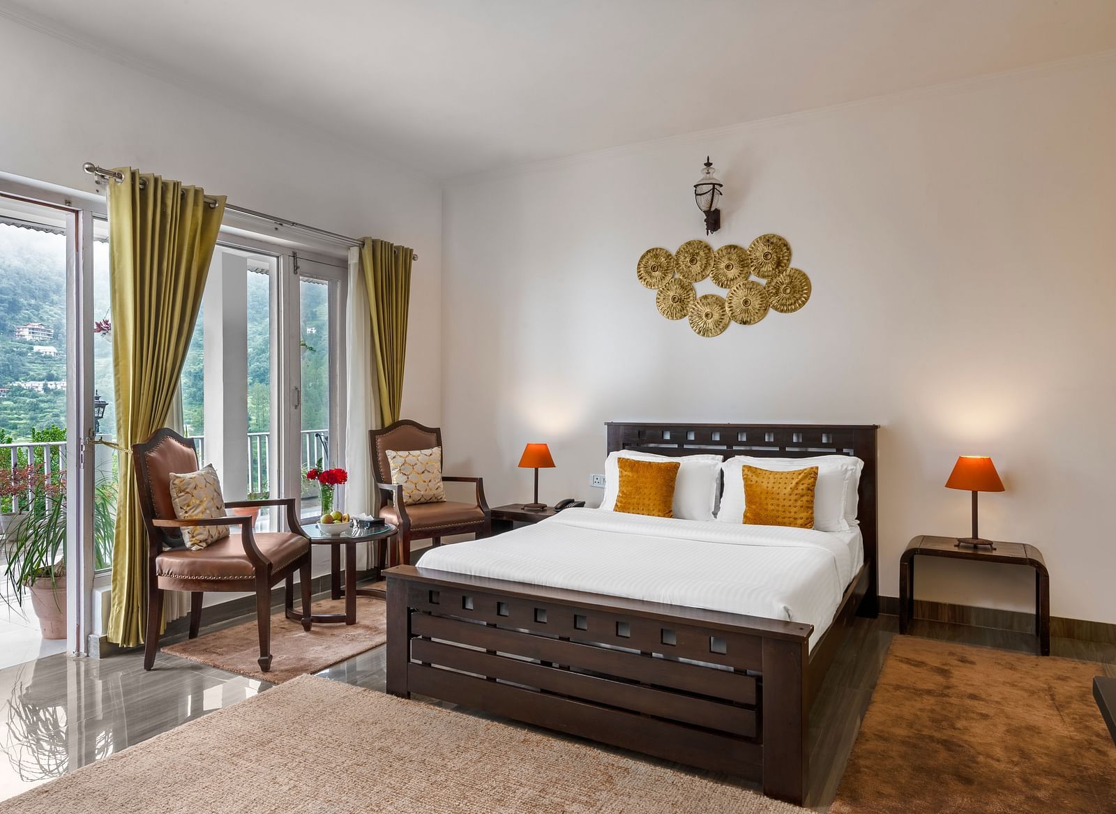 Spacious bedroom with large bed, seating area, and balcony access, at BluSalzz Collection - Suvaasa Resort, Ramgarh.