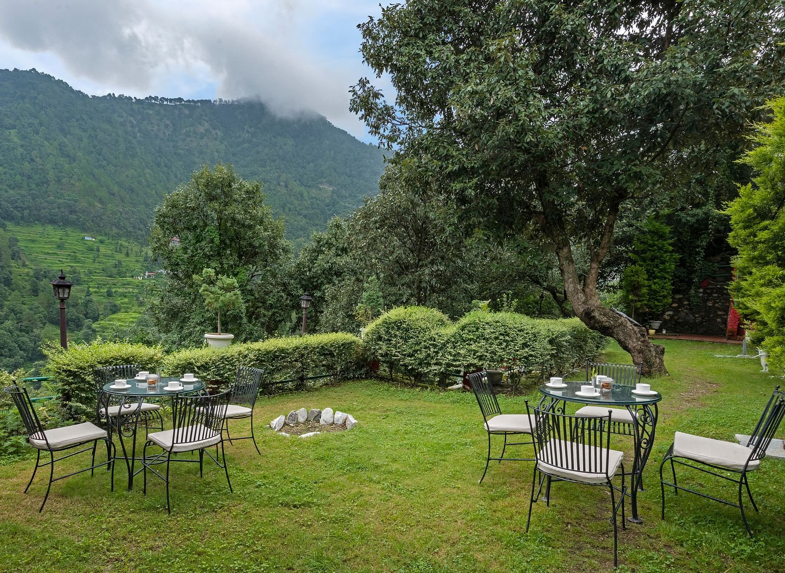 Outdoor lawn seating arranged in a circle with mountain views, at BluSalzz Collection - Suvaasa Resort, Ramgarh.