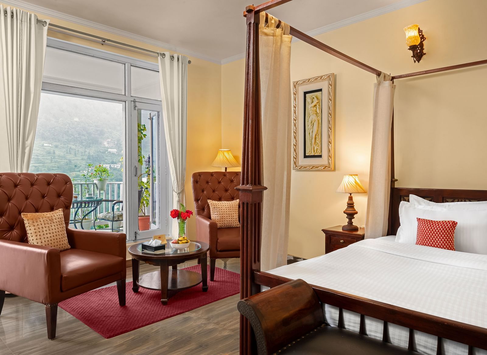 Elegant bedroom with a cosy seating area and a mountain-view balcony at BluSalzz Collection - Suvaasa Resort, Ramgarh.