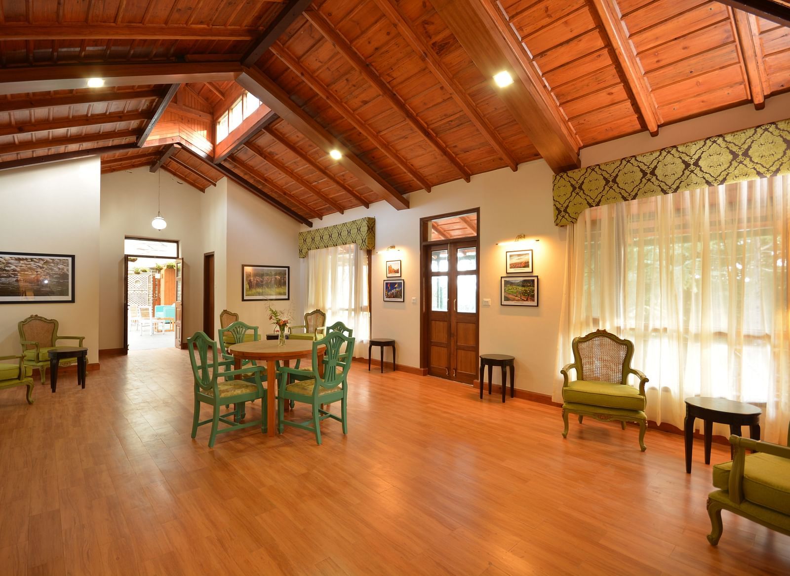 A brightly-lit hall in Almora with vintage-style furnishings and large windows - BluSalzz Escapade - Anant Rasa Resort