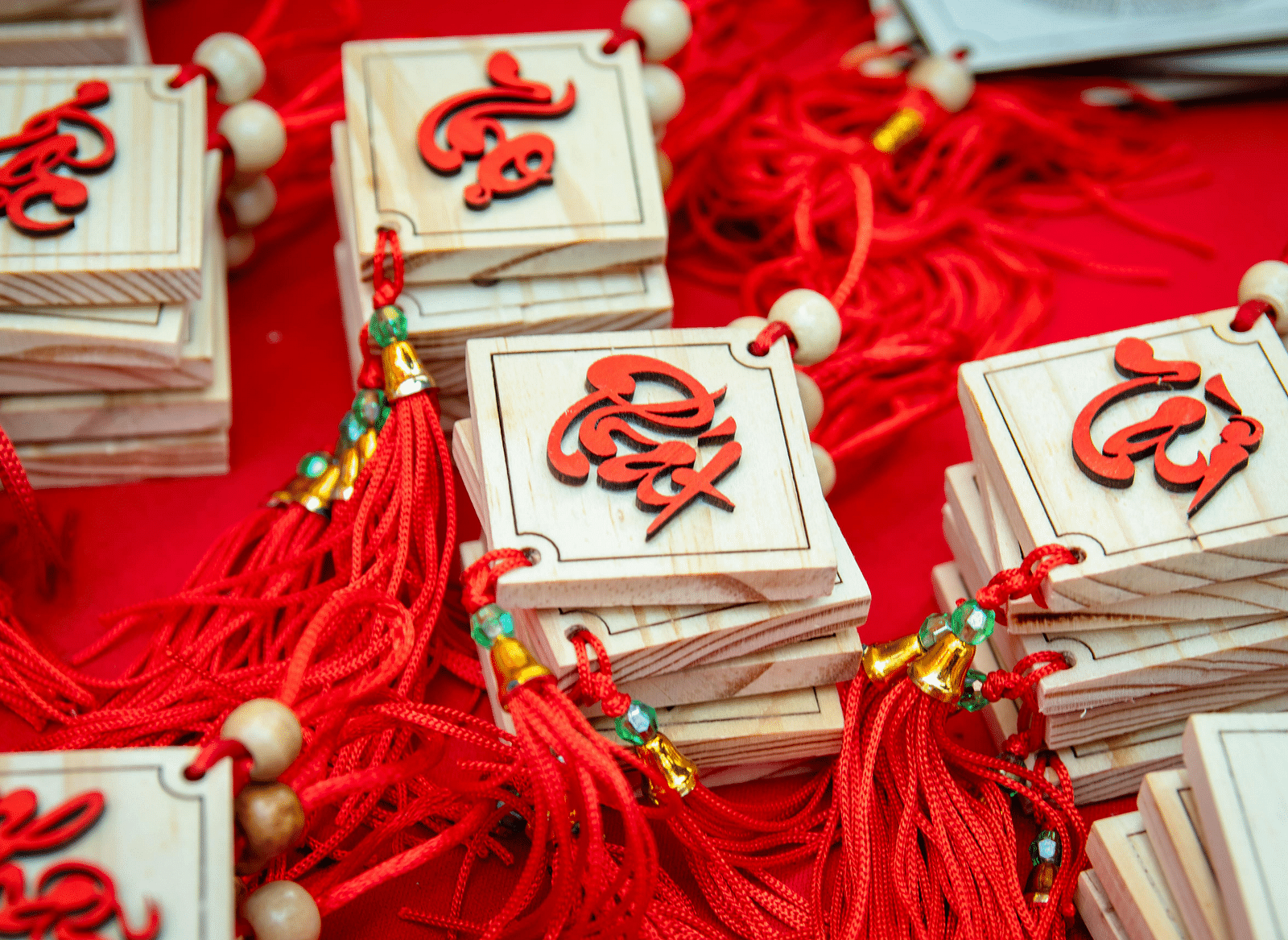 A close-up of decorative Chinese New Year ornaments with red tassels. 