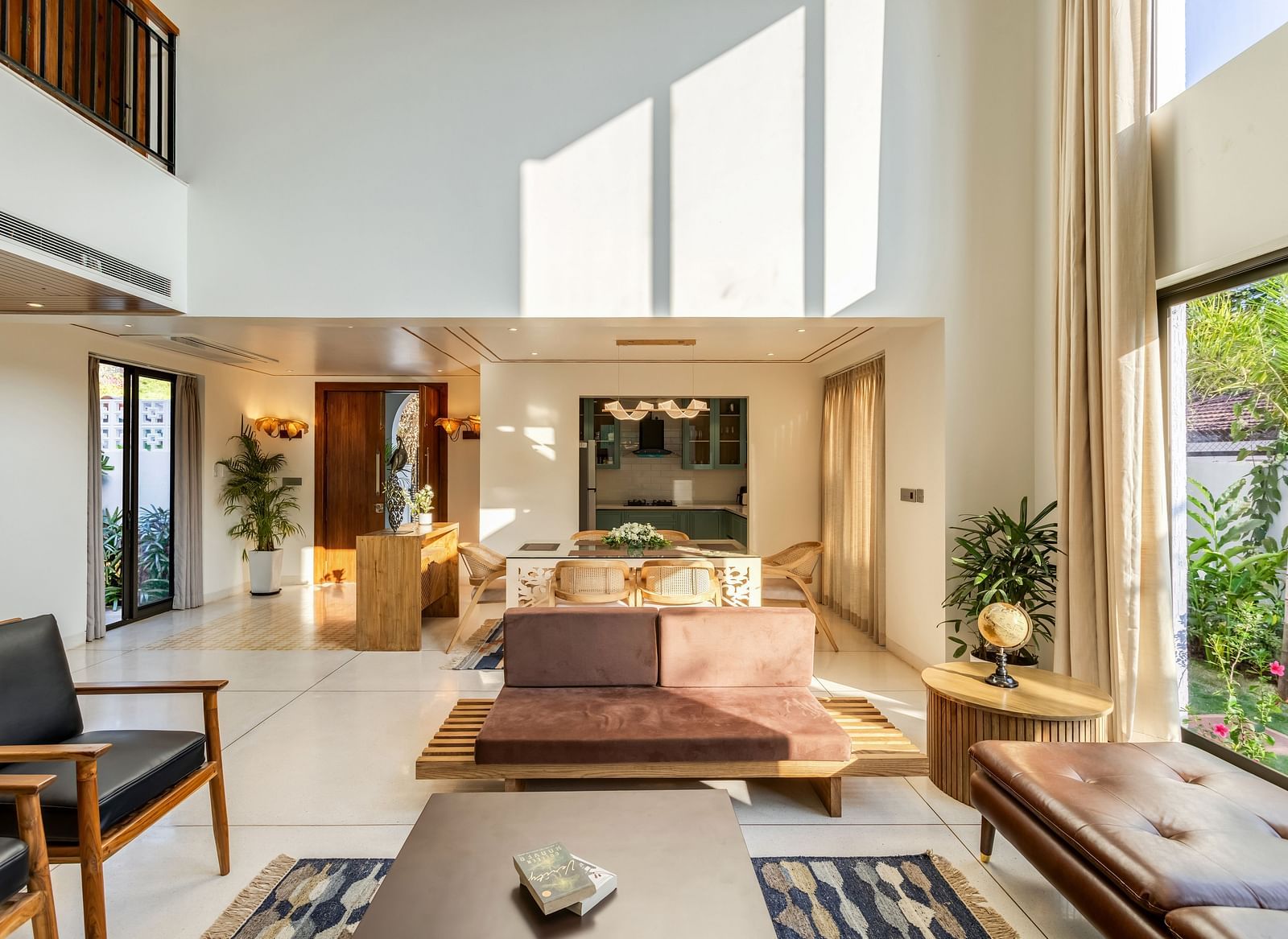 A stylish living area with a minimalist design, ample sunlight, and an open layout connecting to the outdoors - BluSalzz Villas - Alocassia, Anjuna