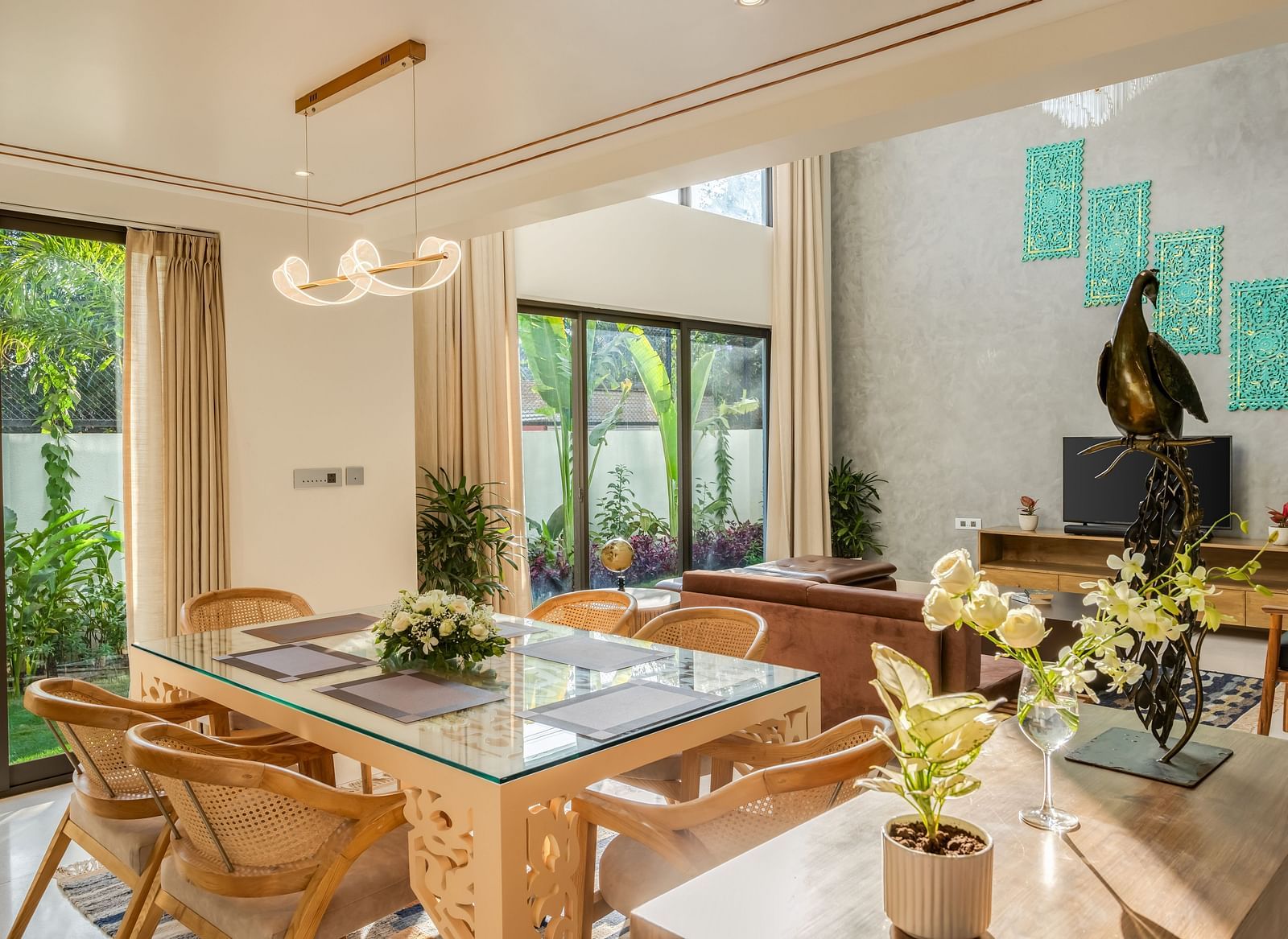 A contemporary dining area featuring a large wooden table, stylish chairs, and abundant natural light streaming through the windows.