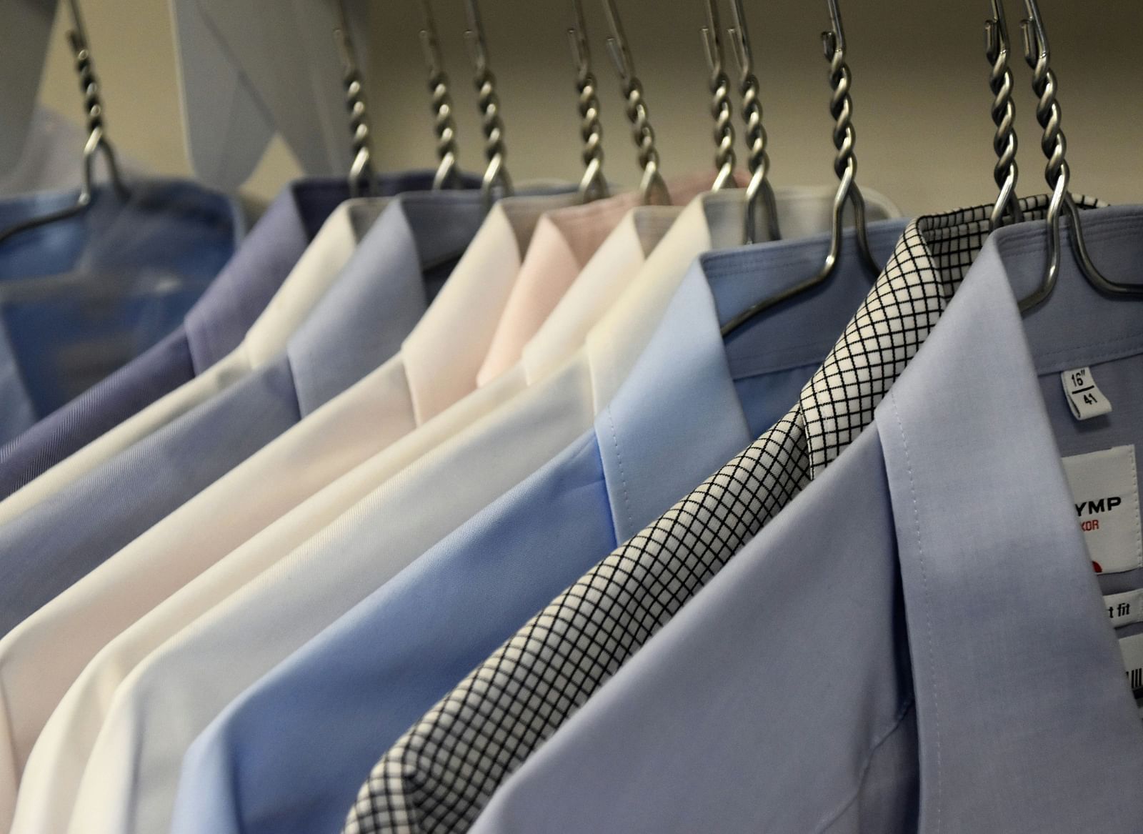 a close-up shot of shirts hanging from hangers