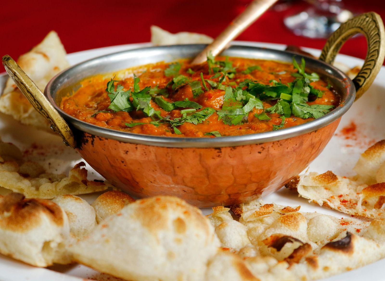 A delicious Indian dish of butter chicken served with naan bread.
