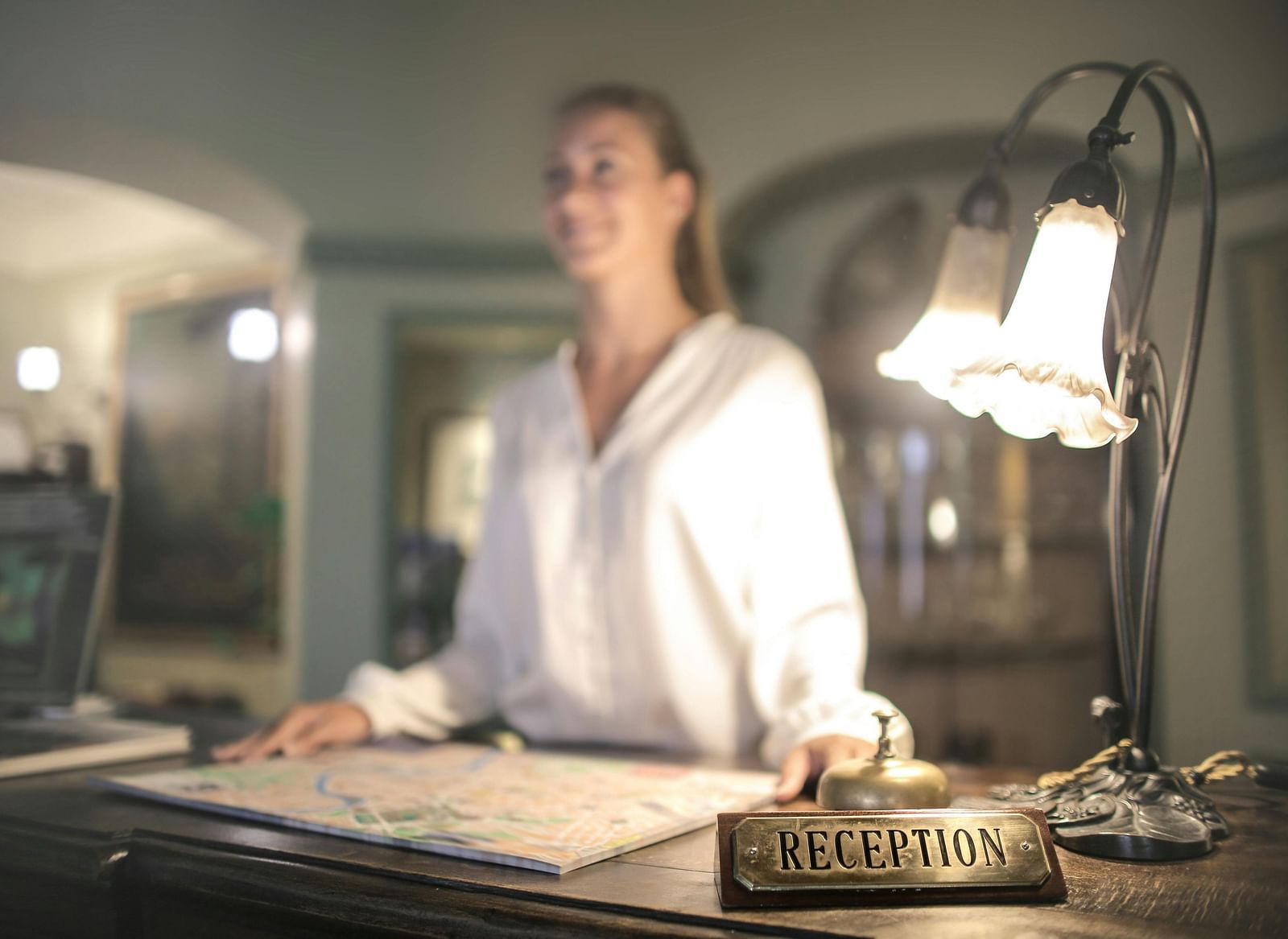 Image of a lady at the reception desk.