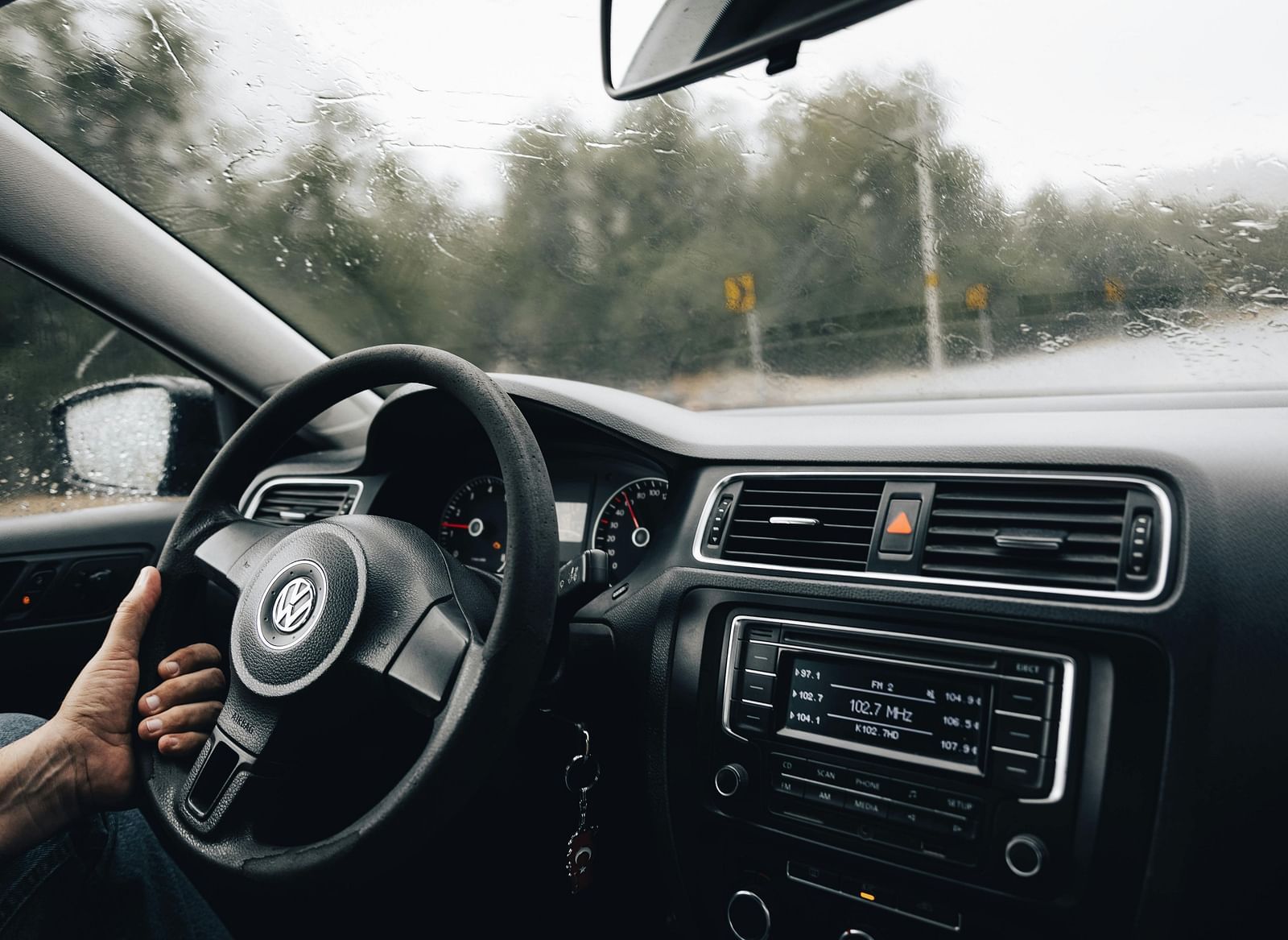 a person driving a car on rainy day