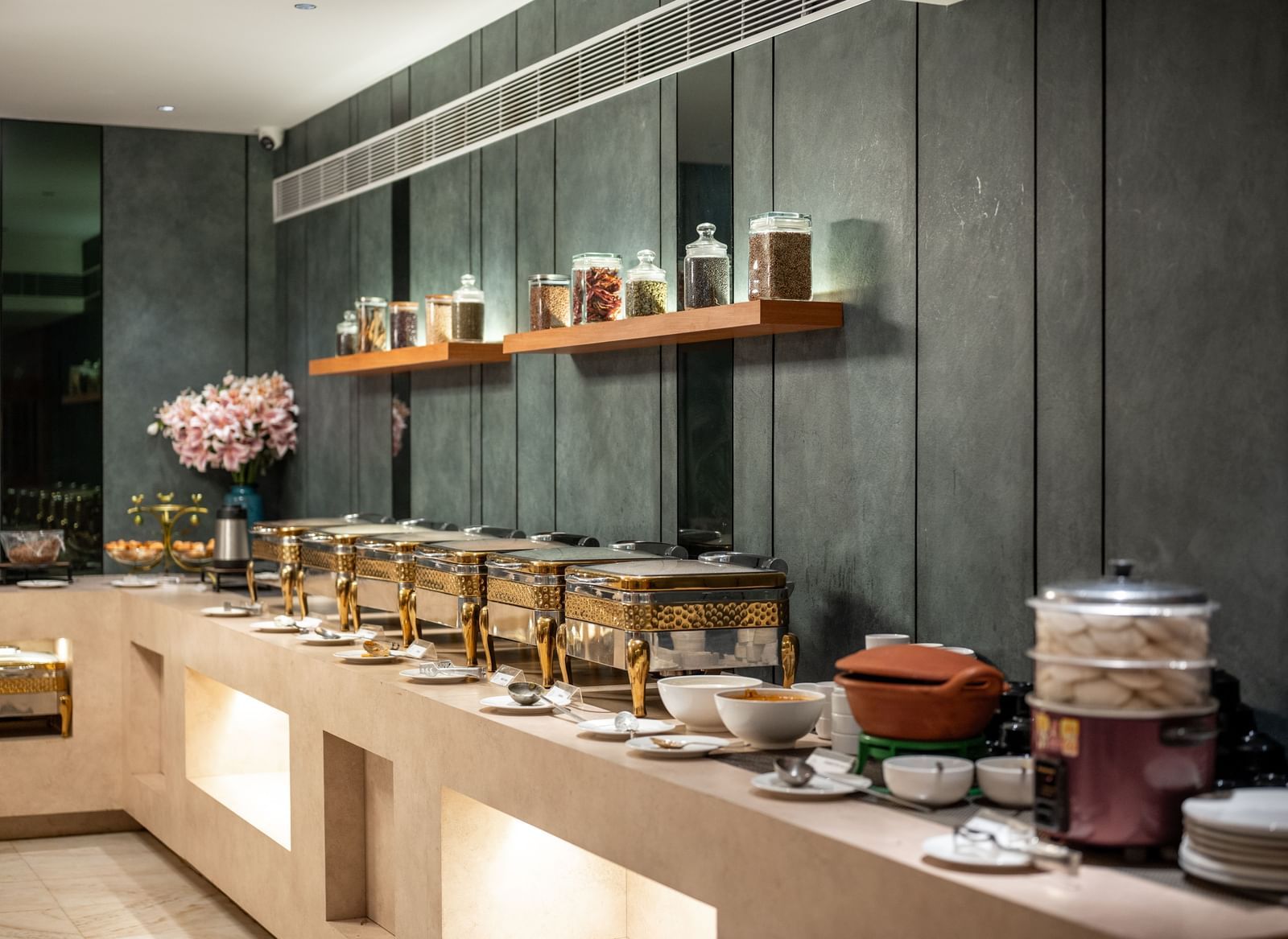 Buffet spread with assorted jars and traditional pots at Hotel Royal Regency Chennai