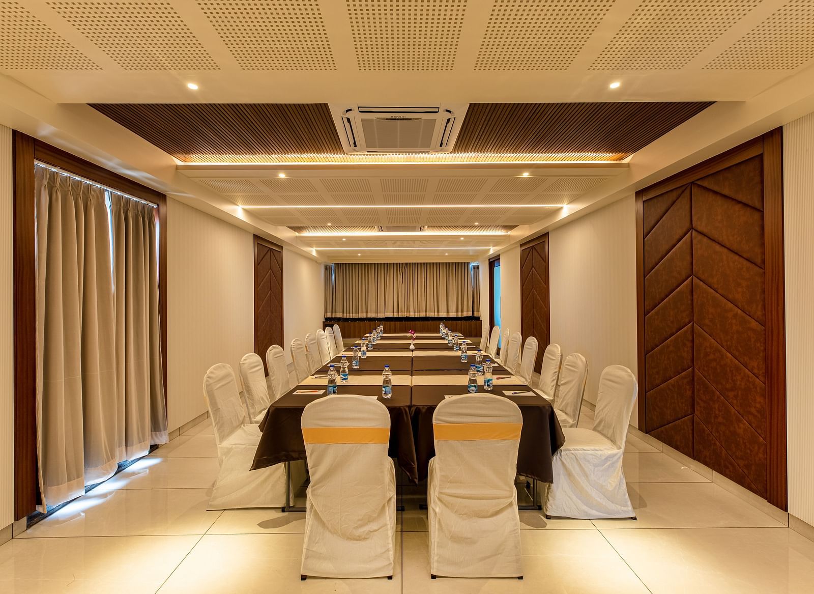 Image of a boardroom featuring a table surrounded by chairs at M Pro Palace.
