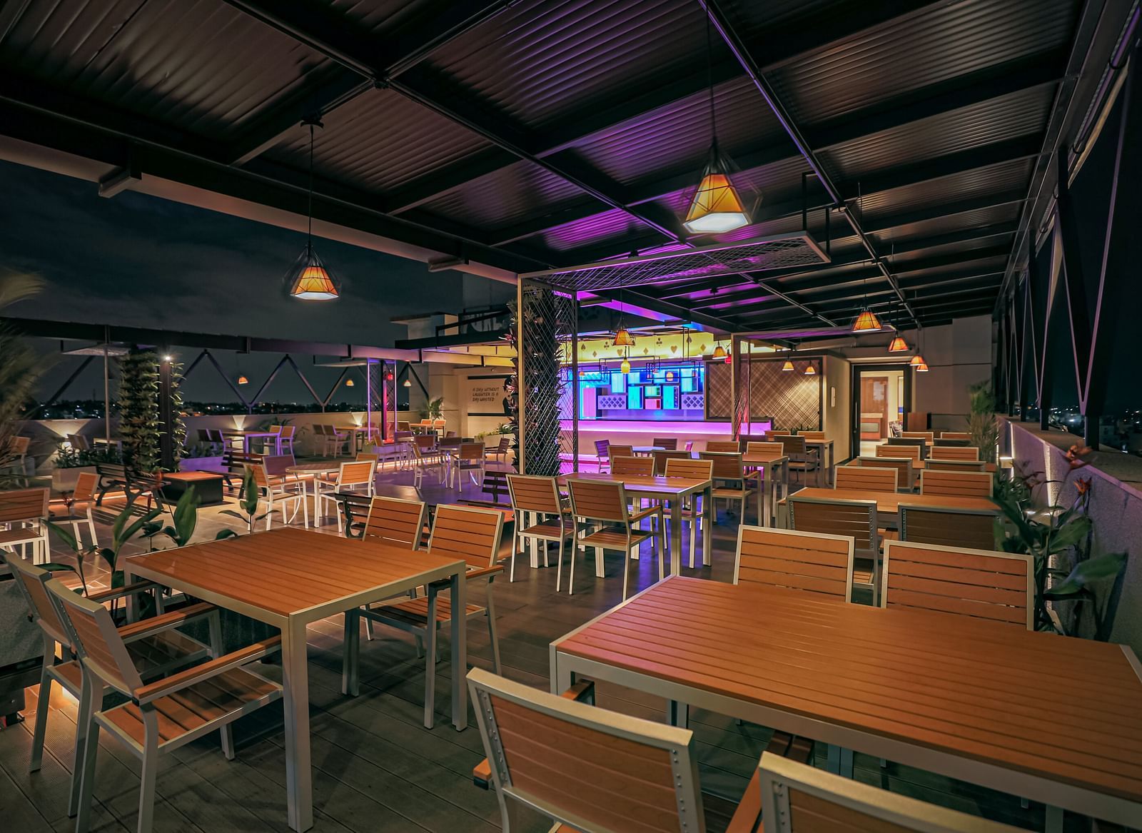 Image of a dining area with wooden tables and chairs at M Pro Palace.