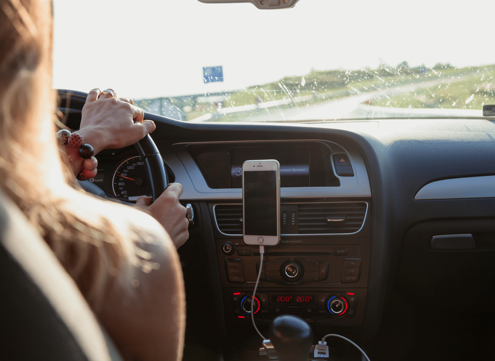 A person driving a motor car on a motorway.