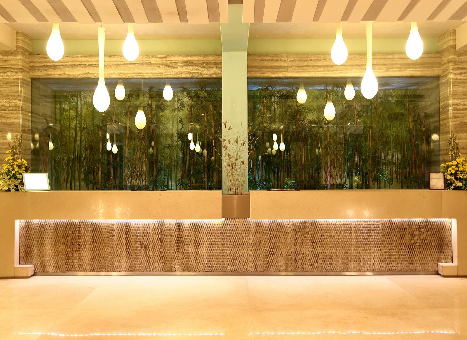 Image of the reception featuring unique lights and a front desk | Mirage Hotel
