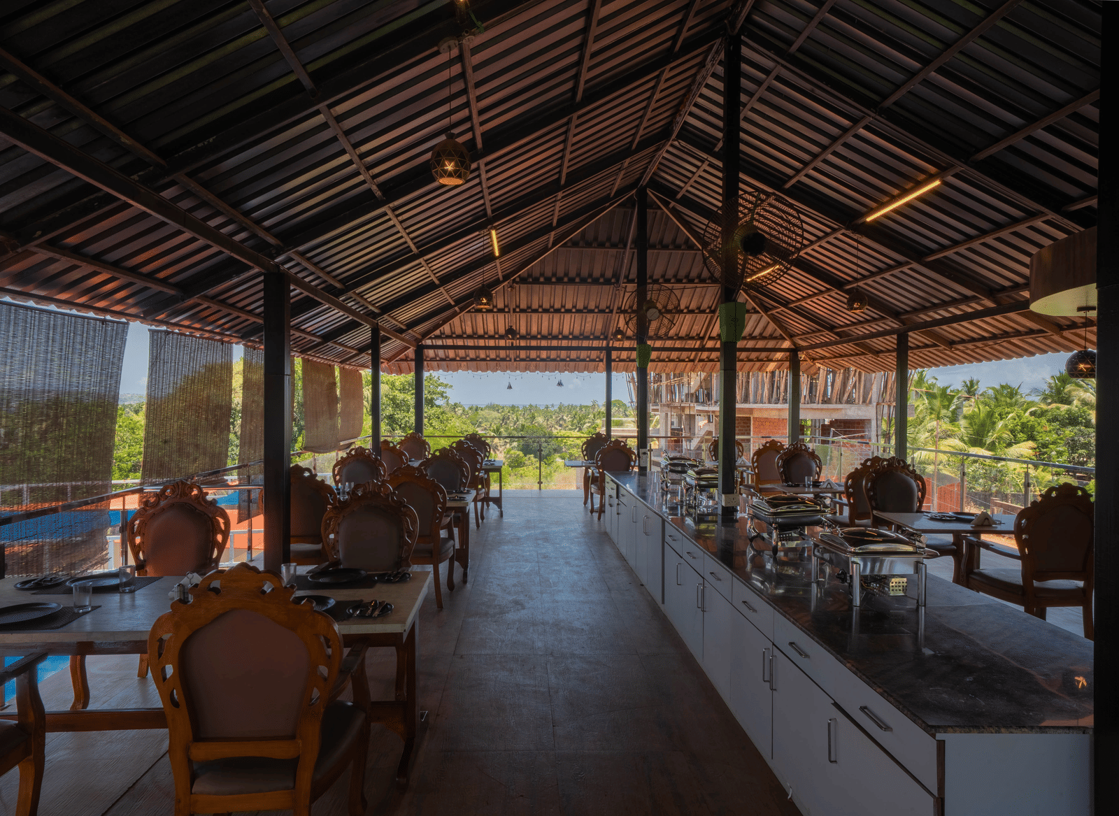 Our restaurant in Goa featuring 4-person seating tables and a buffet counter at the centre - Perfectstayz Koko Maya