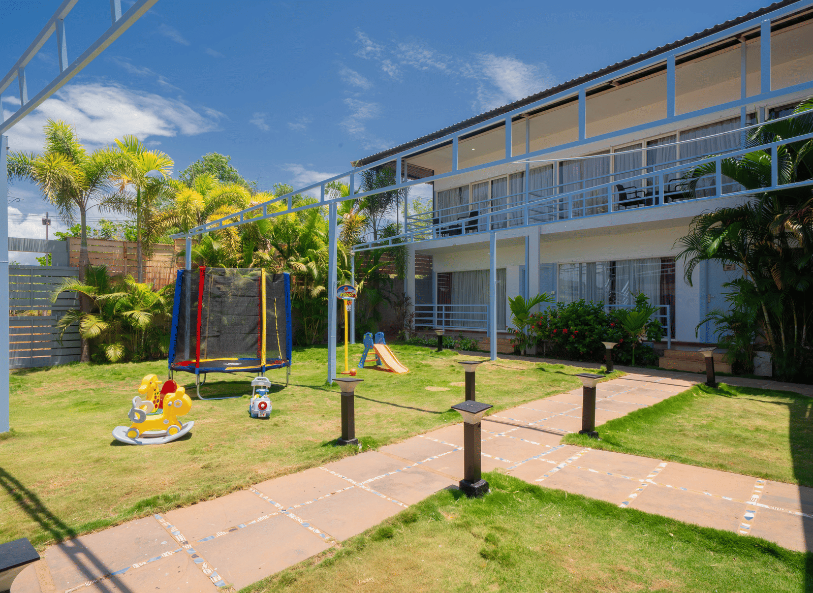 The kids’ play area featuring a mini trampoline, a small slide, and horse-shaped rocking chairs - Perfectstayz Koko Maya