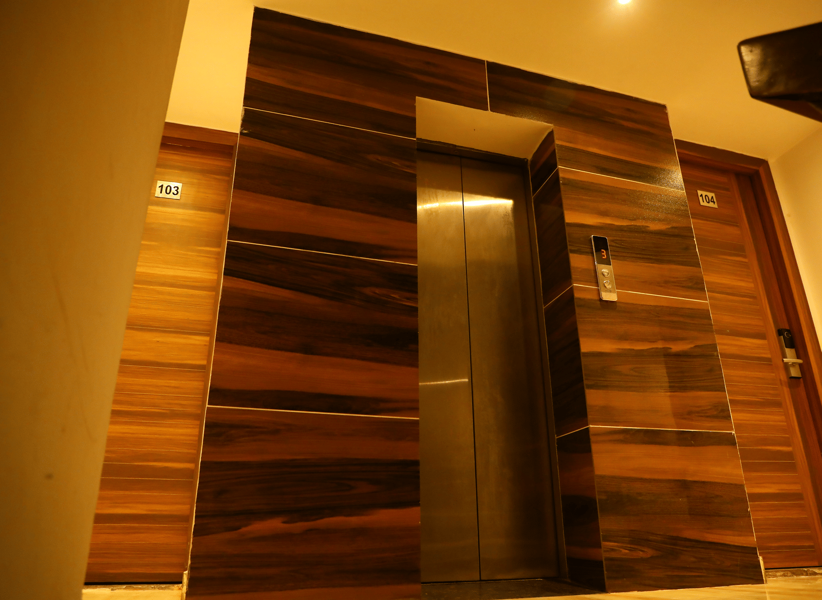 Modern elevator area with polished wooden panelling - Perfectstayz Premium at Har Ki Pauri Road (Ganga Heights)