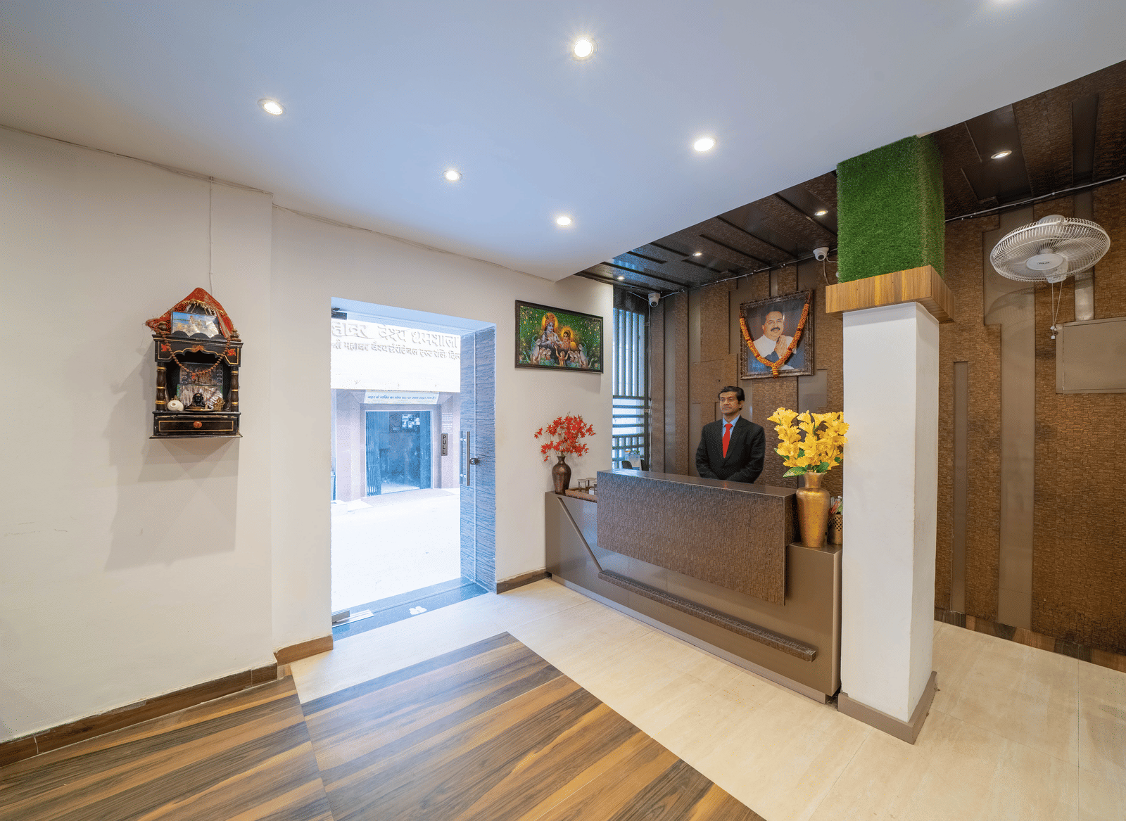 Hotel reception area with a check-in desk, warm lighting, and wood panelling - Perfectstayz Premium at Har Ki Pauri Road (Ganga Heights)