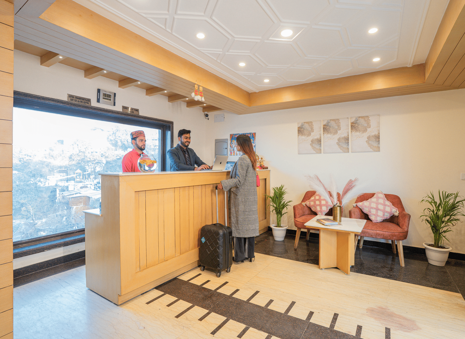 A hotel reception area with a desk and seating at Perfectstayz Premium at Mall Road Hotel Super, Mussoorie.