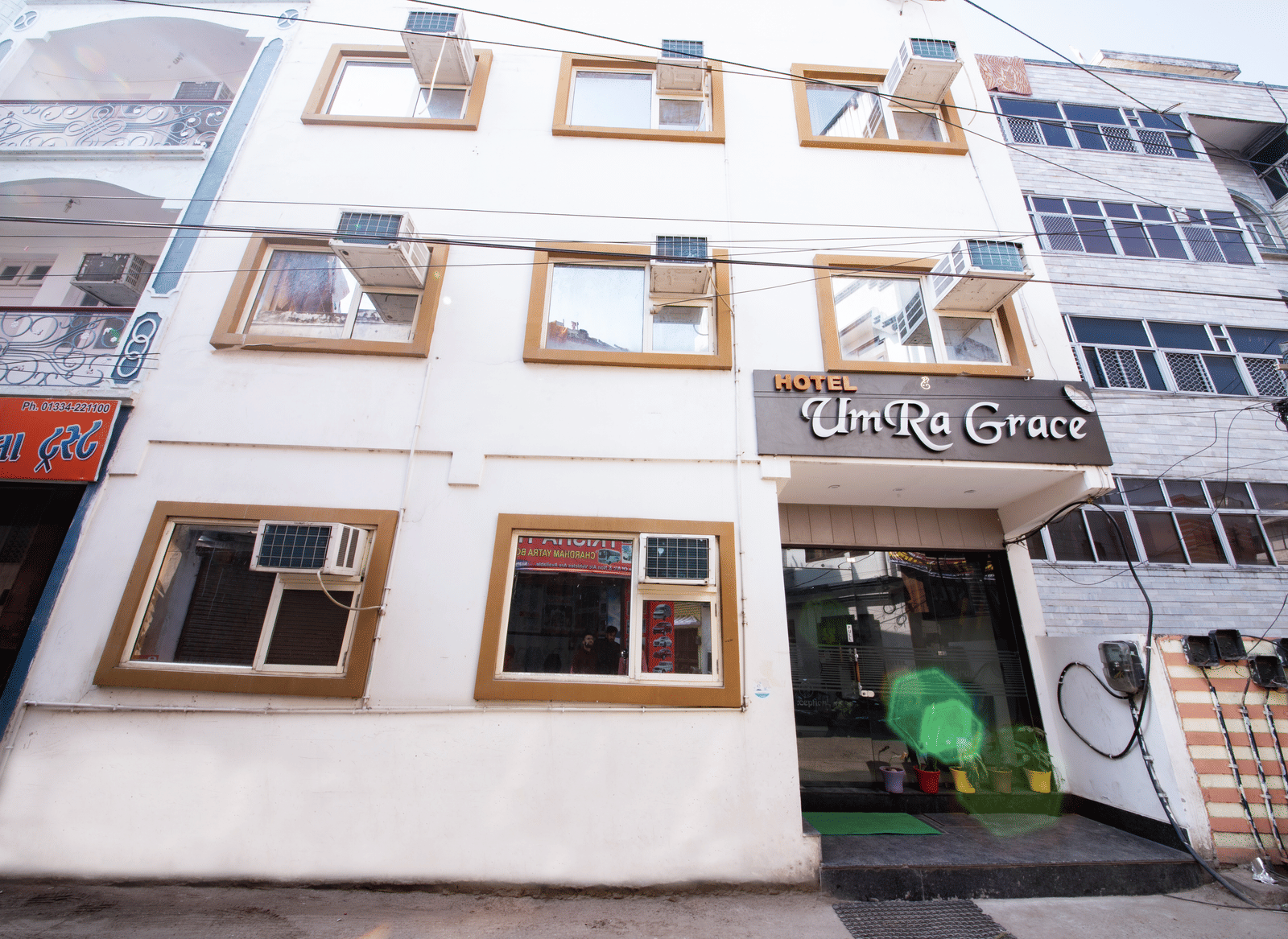 Exterior view of the multi-story hotel building with many windows - Perfectstayz Value Umra Grace, Haridwar