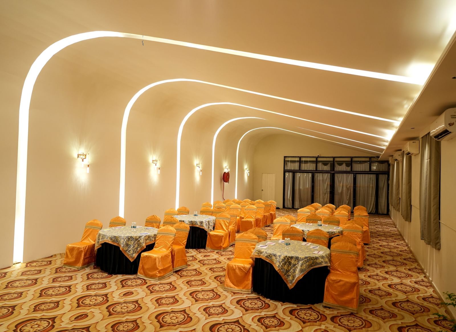 Elegant dining area with warm lighting and stylish seating at Pravasa Hotel Kolhapur.